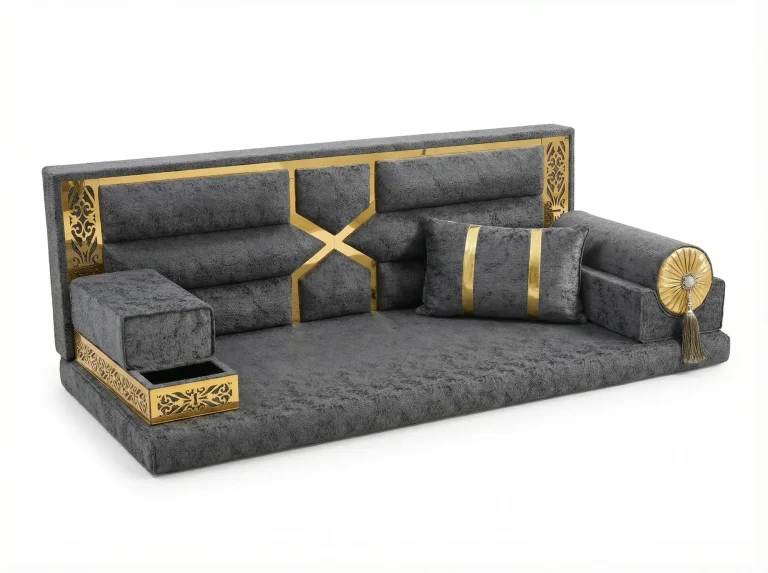 Anthracite textured majlis sofa with a gold-framed back, crossed gold bands and a pierced tray armrest