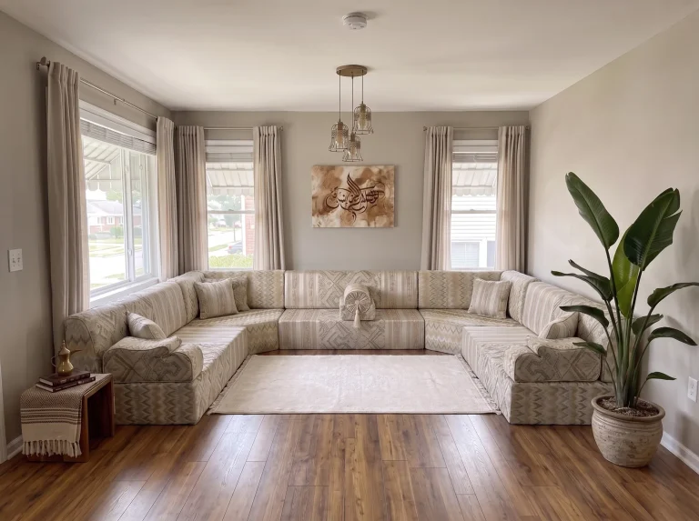 Beige flame-kilim U-shaped Arabic jalsa with a cream rug in a grey living room with wood floors