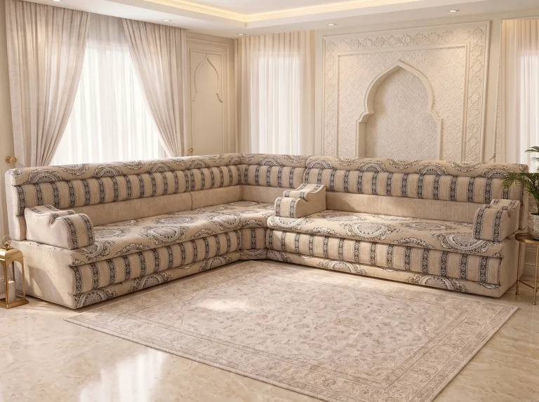 L-shaped beige Arabic majlis with medallion seats and charcoal-striped backrests on a marble floor