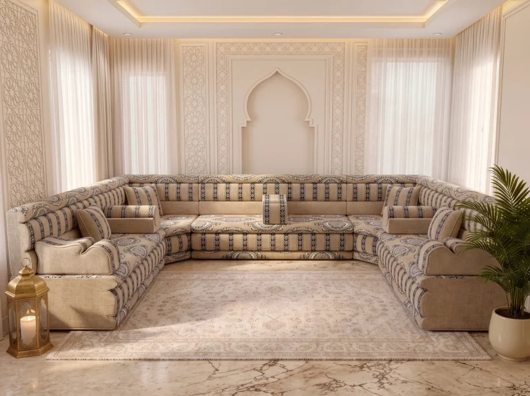 Beige U-shaped Arabic majlis with charcoal medallion and striped fabric around a cream rug