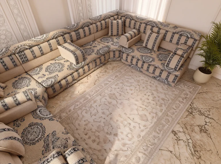 Overhead view of beige seat mattresses with bold dark medallions in a U-shaped Arabic majlis layout