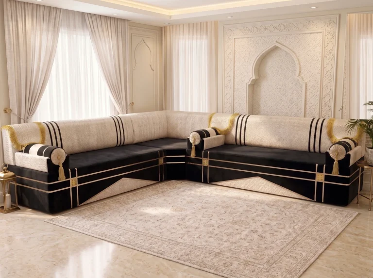 L-shaped black and cream majlis sofa with gold-fringed arm covers and clear seats beside a cream rug