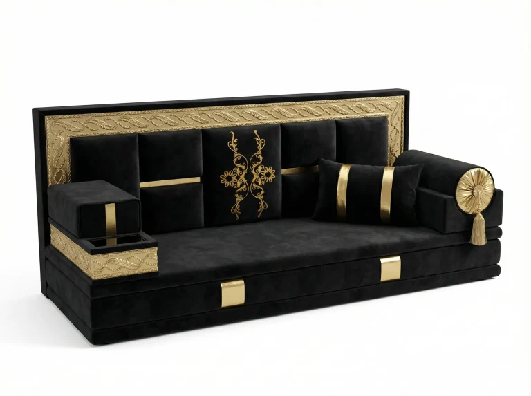 Black velvet majlis sofa with a gold embossed frame, gold floral embroidery and a rosette bolster
