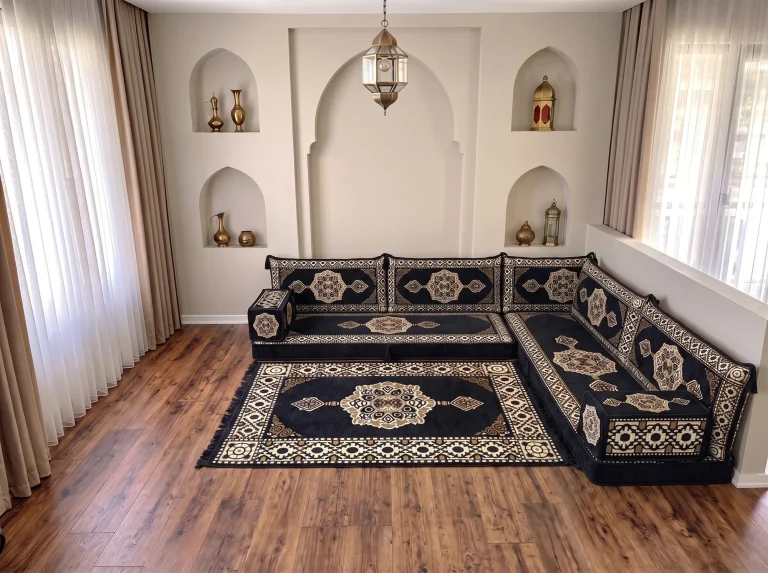 Black and gold Arabic floor couch in an L shape with a matching medallion rug in an arched room