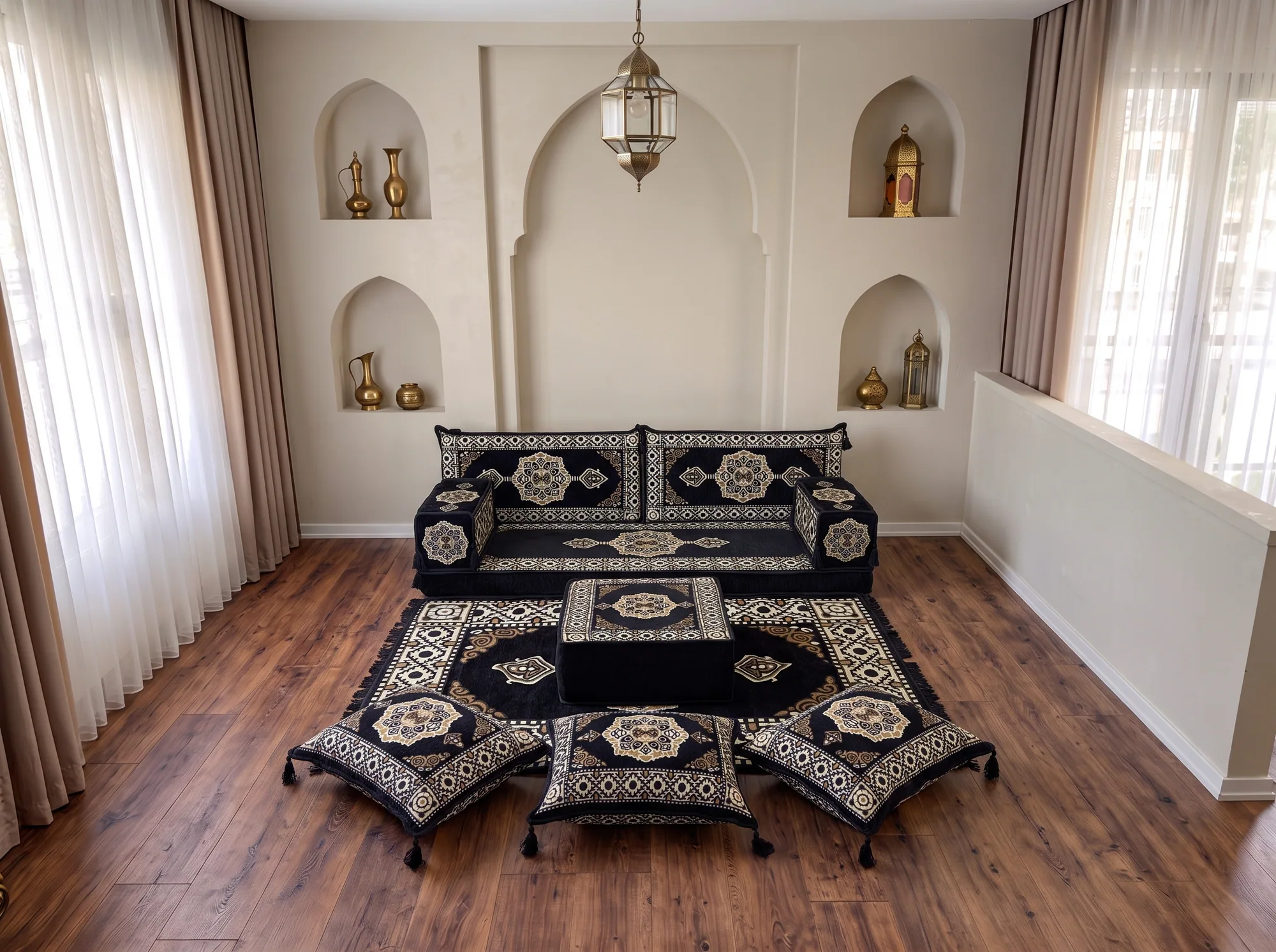 Black and gold medallion Arabic floor sofa with ottoman, rug and three tasselled floor cushions in front
