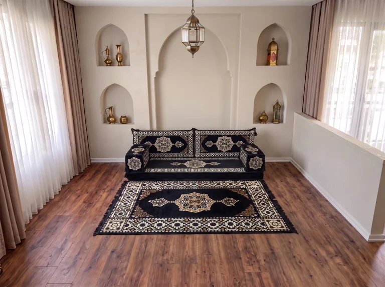 Black and gold floor sofa set with two back cushions behind a large matching medallion rug on a wooden floor