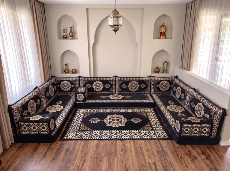Black and gold medallion Arabic sofa in a U shape with a matching rug filling the centre of the room