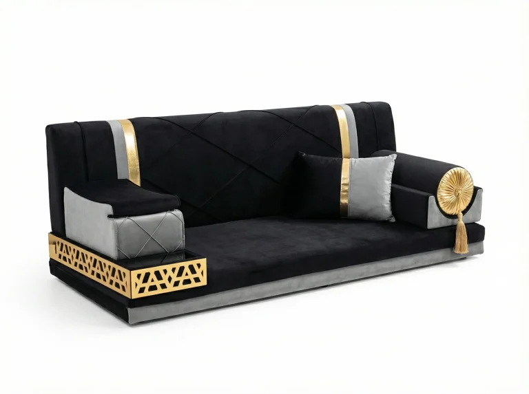 Low black velvet majlis sofa with grey accents, a gold laser-cut tray armrest and a gold rosette bolster with tassel
