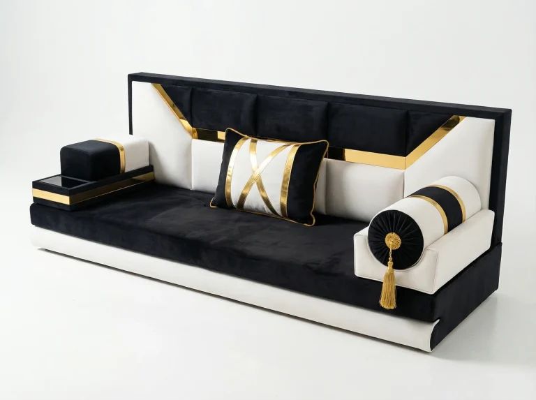 Black and ivory velvet majlis sofa with a tall framed backrest, angled gold bands, a tray armrest and a bolster