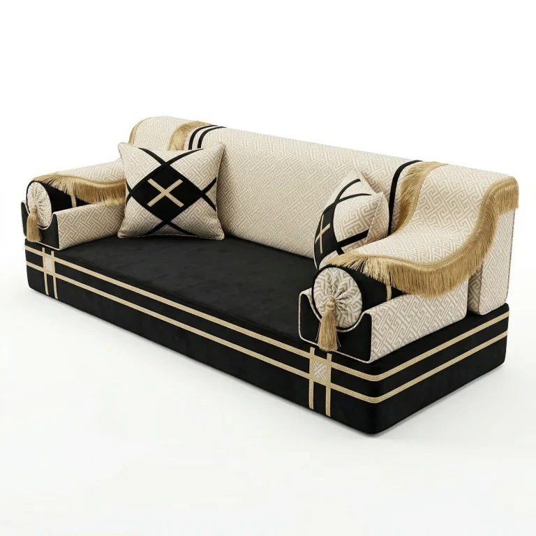 Black velvet majlis seating unit with ivory key-pattern back and armrests, gold fringe throws and tasselled bolsters