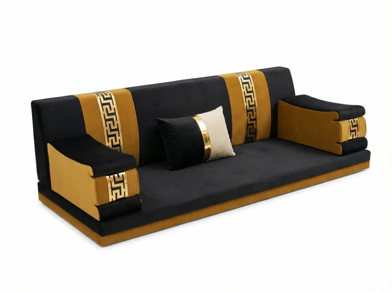 Black velvet majlis sofa with mustard bands and gold key-pattern strips on the backrest and wedge-shaped armrests