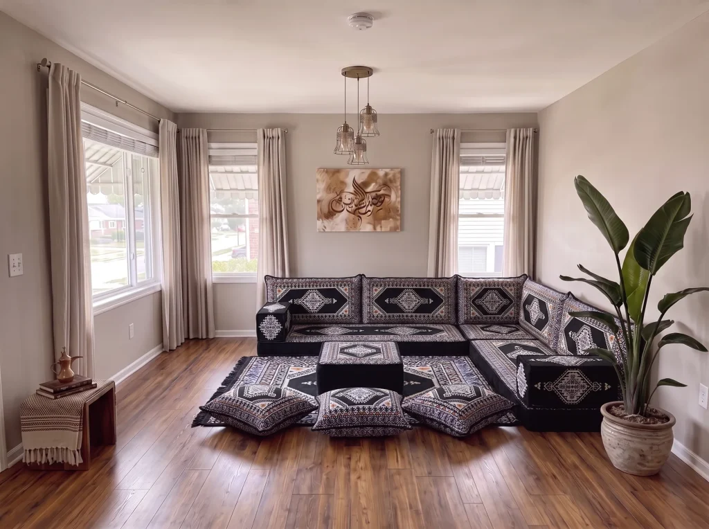 Black kilim Arabic floor sofa with cream diamond motifs in an L shape, with ottoman, rug and three floor cushions