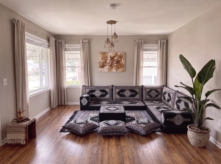 Black kilim Arabic floor sofa with cream diamond motifs in an L shape, with ottoman, rug and three floor cushions