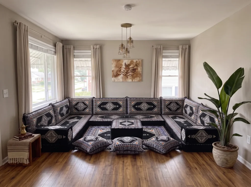 Black kilim floor sofa set in a U shape with ottoman, matching rug and three floor cushions in a living room