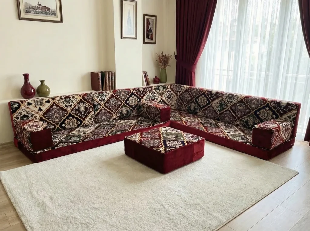 Burgundy carpet-pattern floor seating set in an L shape with a matching ottoman on a cream rug