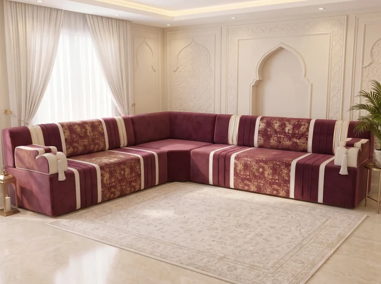 L-shaped burgundy velvet Arabic jalsa with cream stripes and gold damask panels on a polished marble floor