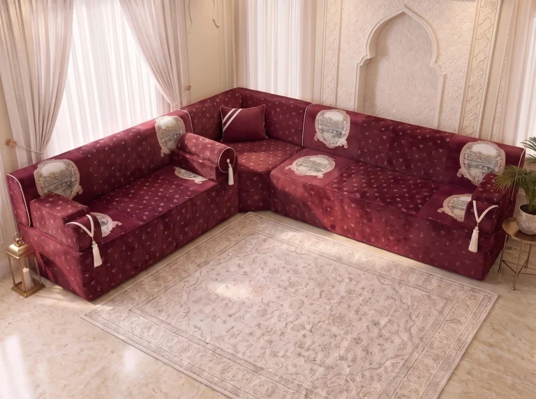 Elevated view of a burgundy velvet Arabic jalsa in an L shape showing tapestry panels on seats and backs