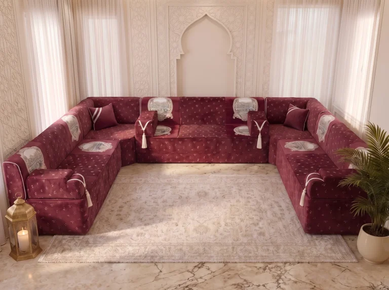 Elevated front view of a burgundy velvet Arabic majlis in a U shape with tapestry panels on every seat