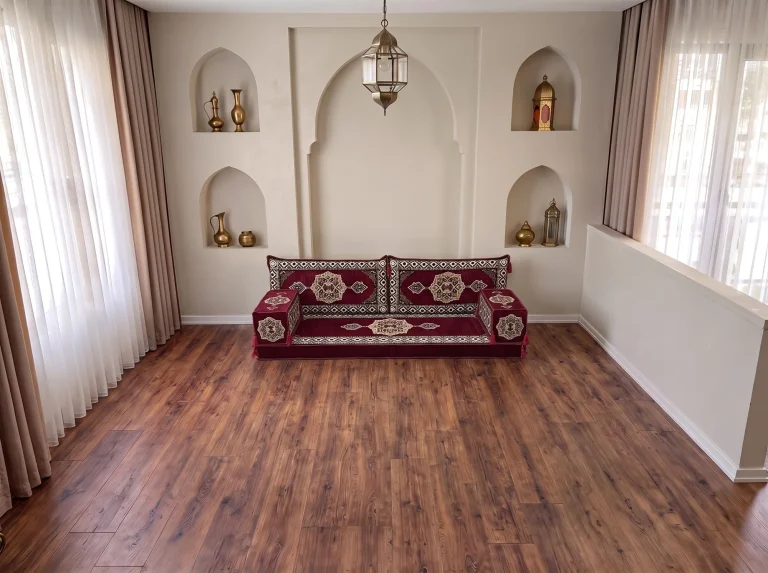 Burgundy medallion single-row floor sofa set on a bare wood floor in a niche-walled reception room