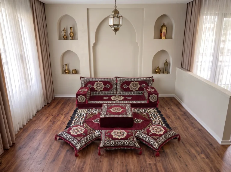 Burgundy medallion single-row Arabic floor sofa with rug, ottoman and floor cushions in a niche-walled reception room
