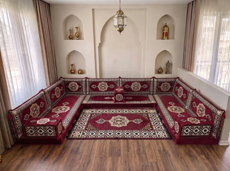 Burgundy medallion U-shaped floor seating set with a matching fringed rug in a niche-walled reception room
