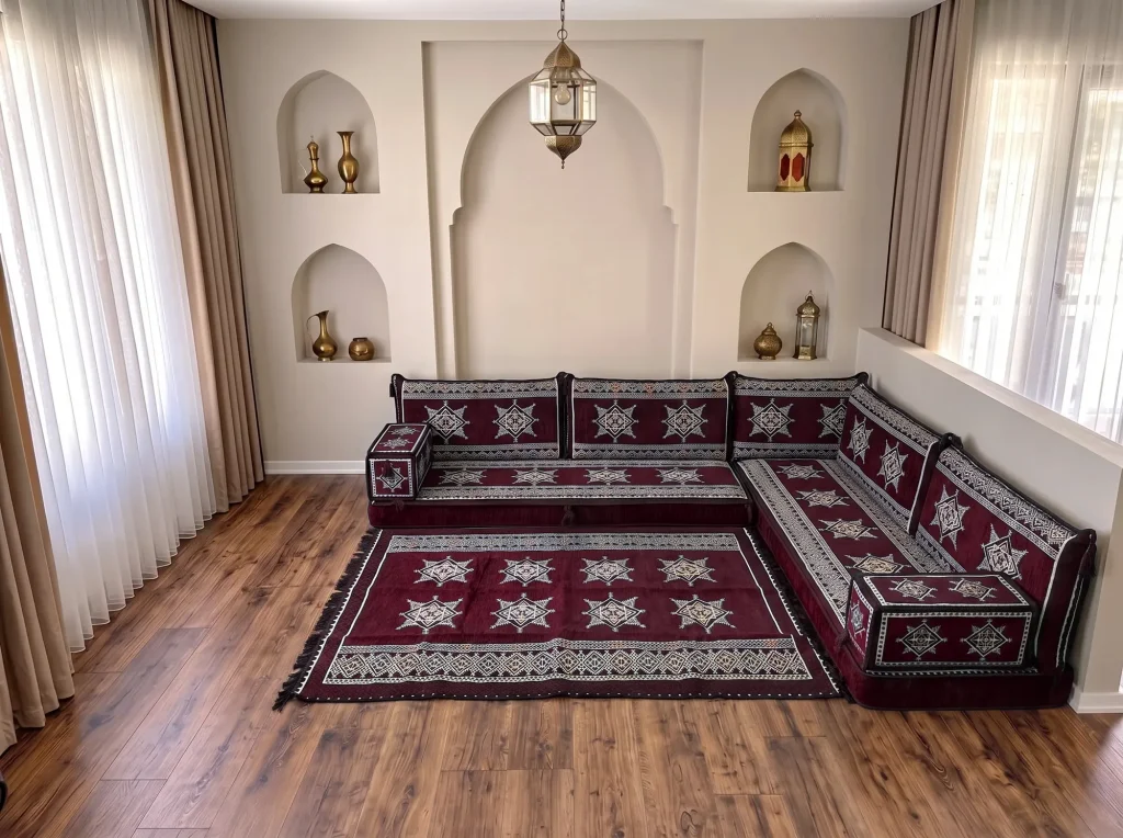 Burgundy star-pattern Arabic floor sofa in an L shape with a matching fringed star rug in an arched room