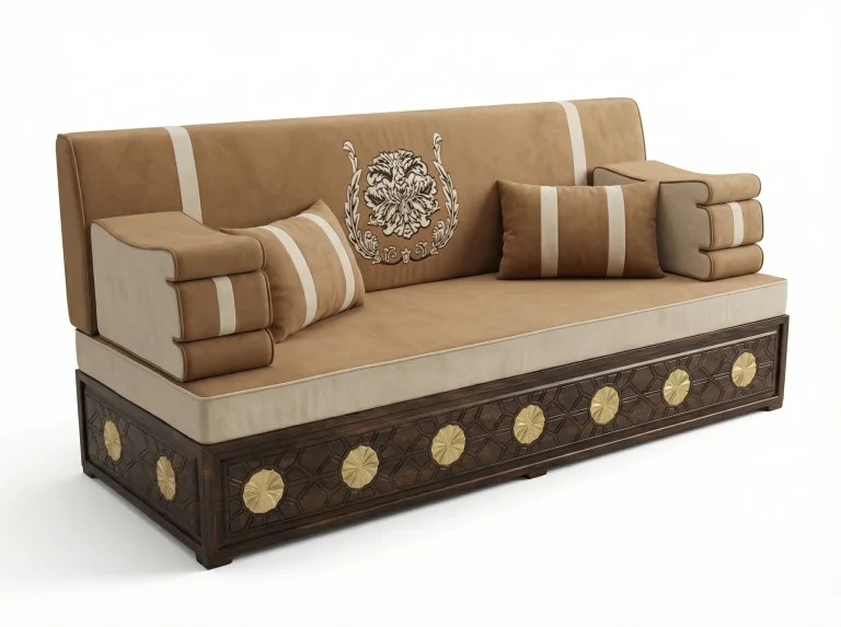 Camel velvet majlis sofa on a carved dark wood base with gold rosettes, an embroidered wreath and striped cushions