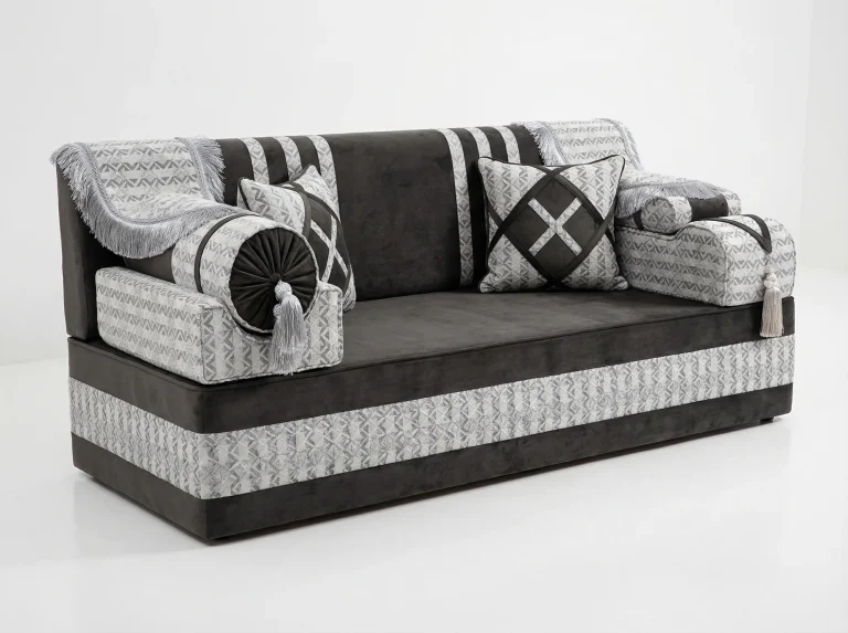 Charcoal velvet Arabic majlis module with silver geometric jacquard bands, fringed throws and a tasselled bolster