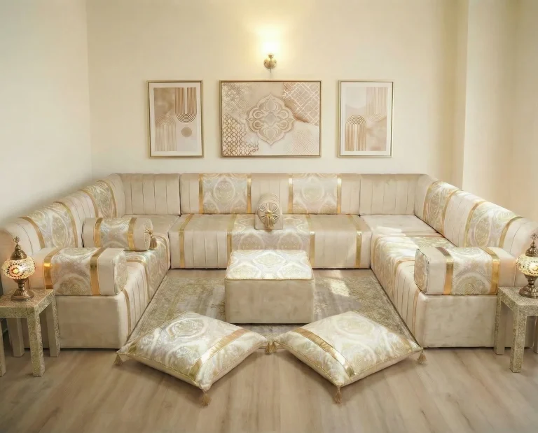 Ivory and gold damask diwan floor sofa in a U shape with two tasselled floor cushions placed as diamonds by the pouf