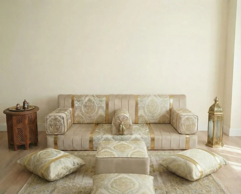 Low ivory and gold damask diwan floor sofa with a low pouf and three floor cushions in front on a pale rug