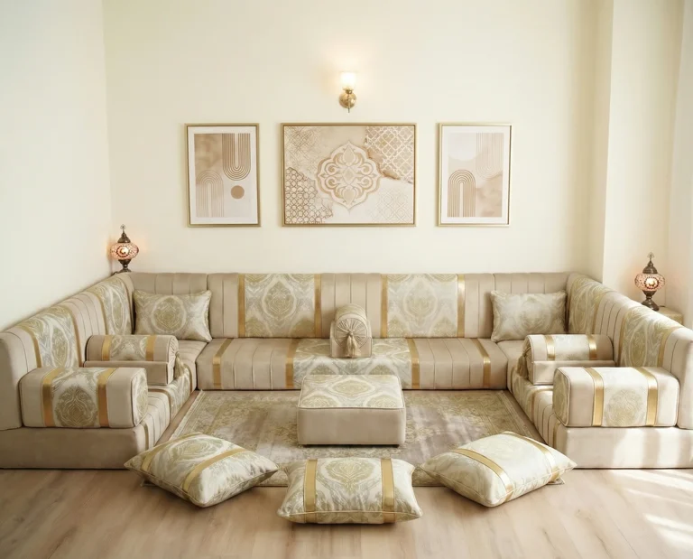 Low ivory and gold damask diwan floor sofa in a U shape with pouf and three floor cushions in a bright cream room