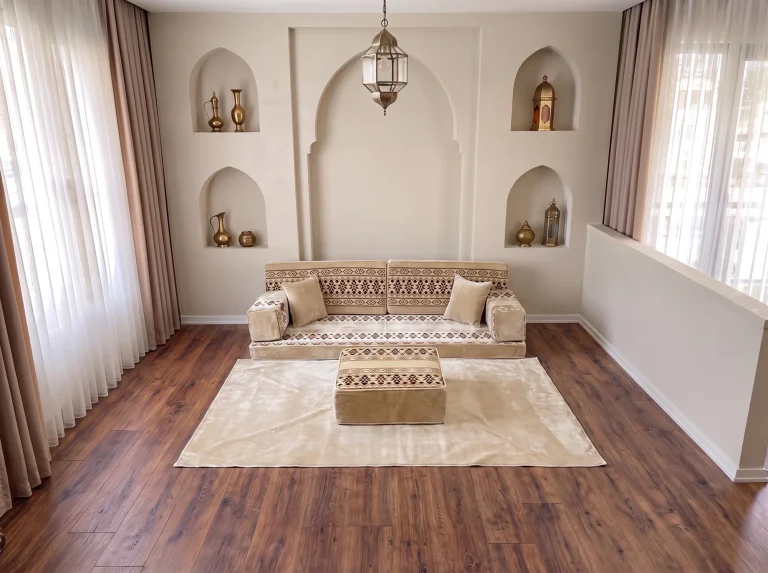 Cream Arabic sofa with burgundy cross-stitch bands as a single row with matching rug and ottoman by arched niches