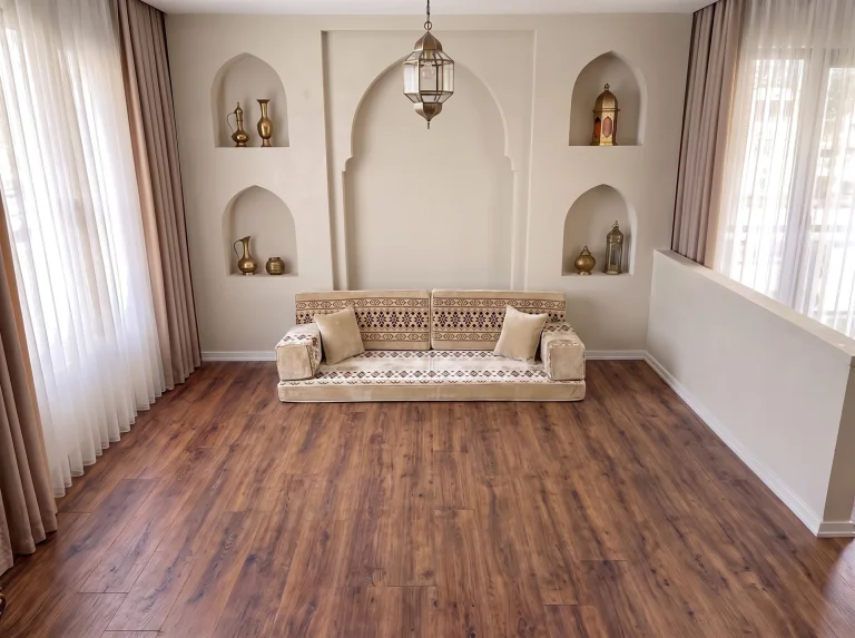 Cream floor seating set with burgundy cross-stitch bands as a single row on a bare wood floor by arched niches