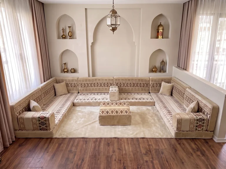 Cream floor seating set with burgundy geometric bands arranged in a U shape, with a cream rug and matching square ottoman