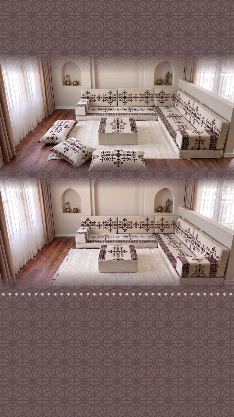 Cream Arabic sofa in an L shape with plum cross-stitch motifs, a matching pouf and floor cushions beside arched niches