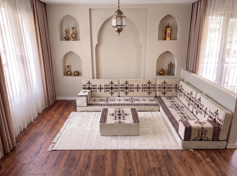 Cream sadu floor sofa set in an L shape with a sadu-topped ottoman on a plain cream rug
