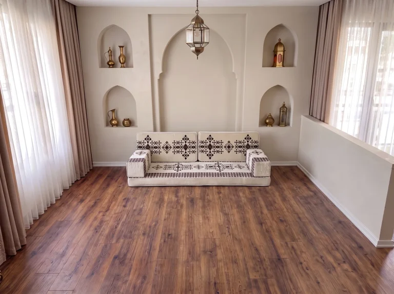 Cream floor seating set with burgundy sadu motifs: one seat, two back cushions and two armrests on a bare floor