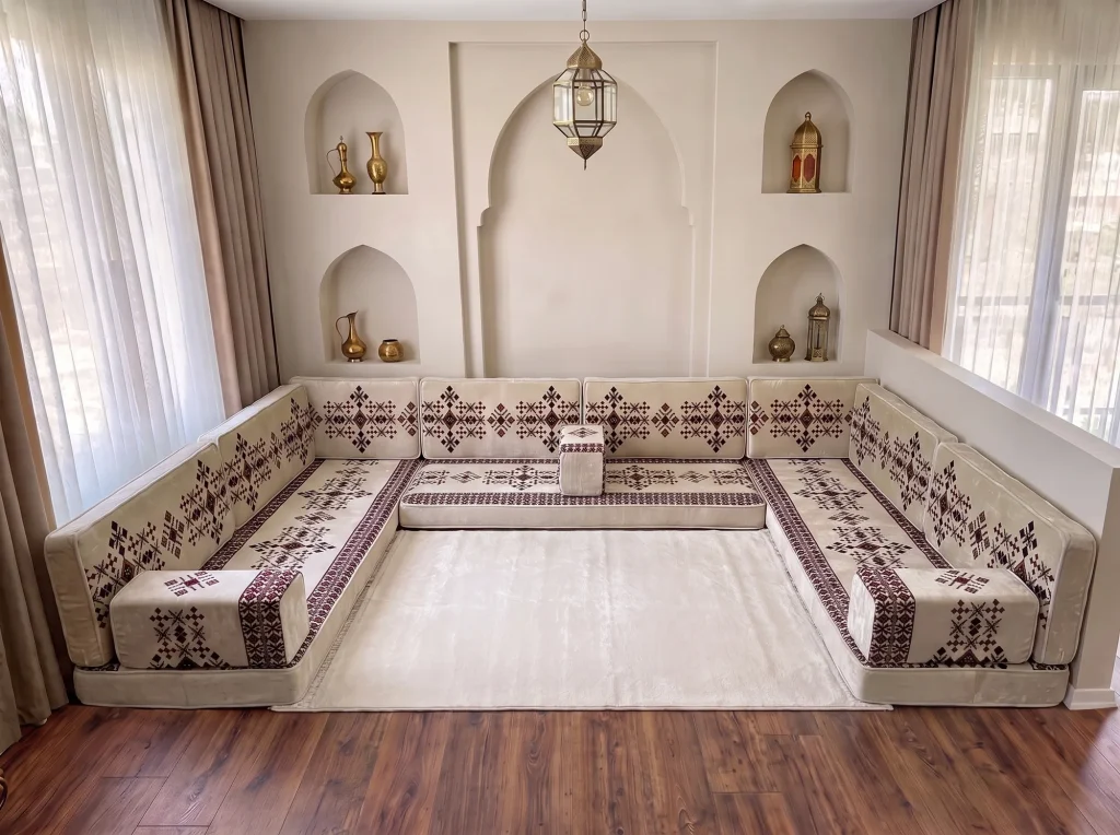 Cream sadu-pattern floor sofa set in a U shape with a plain cream rug filling the centre of the room