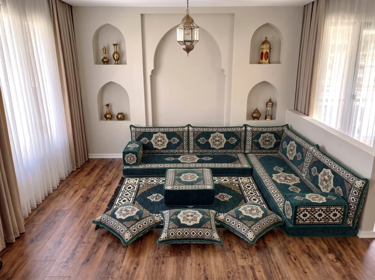 Emerald green and cream medallion Arabic floor sofa in an L shape with rug, ottoman and floor cushions by arched niches