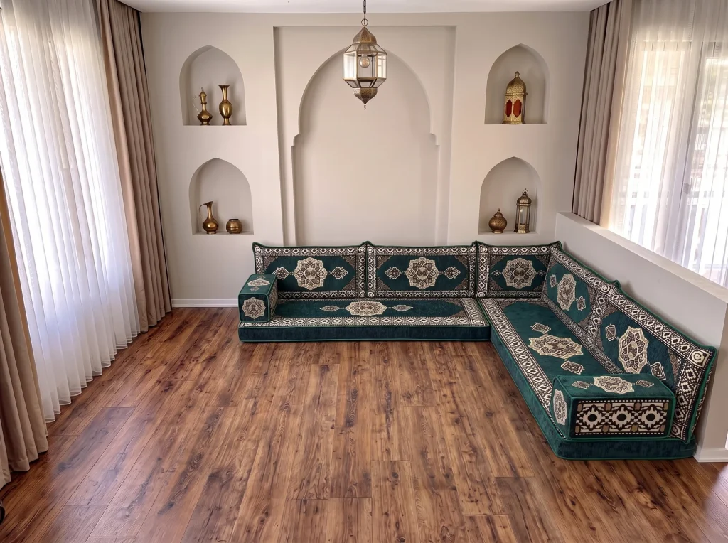Emerald green and cream medallion floor sofa in an L shape in a room with arched wall niches