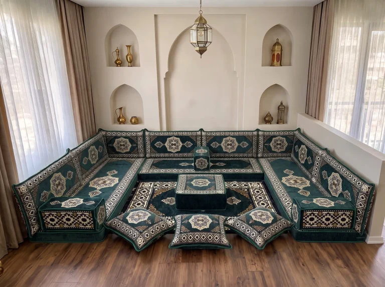 Emerald green and cream medallion Arabic floor sofa in a U shape with rug, ottoman and floor cushions by arched niches