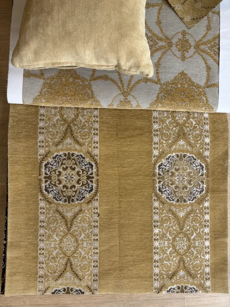 Gold chenille upholstery fabric with two white ornamental bands and round brown medallions