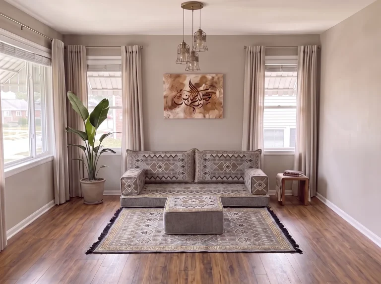 Gray and gold geometric Arabic floor couch as a single row with matching rug and ottoman in a bright living room