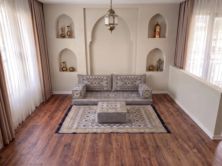 Low gray and gold kilim-pattern Arabic floor couch as a single row with matching rug and ottoman by arched niches