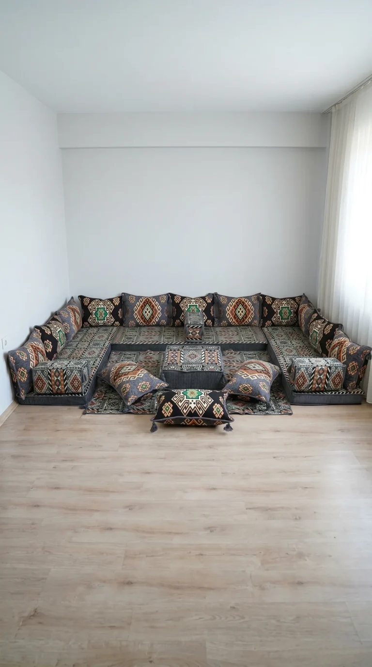 Gray and black kilim-pattern Arabic floor sofa in a U shape with orange and green motifs in a white room