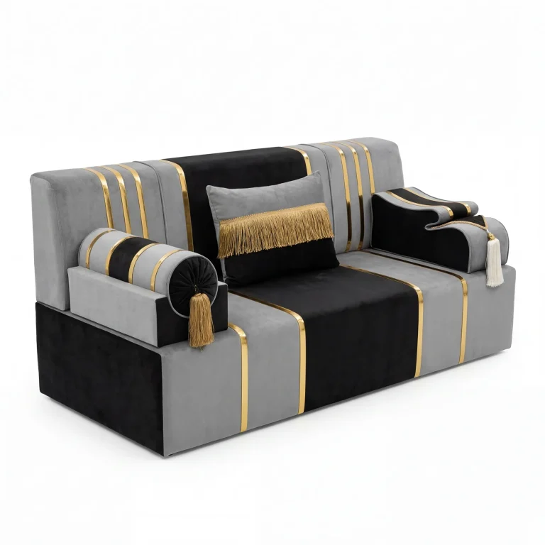 Grey and black velvet majlis sofa unit with metallic gold stripes, a gold-fringed cushion and tasselled armrests