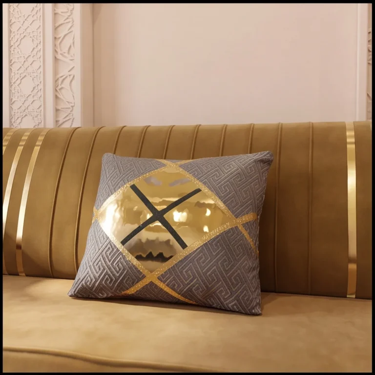 Grey key-pattern throw cushion with a gold diamond panel resting on a mustard velvet majlis sofa