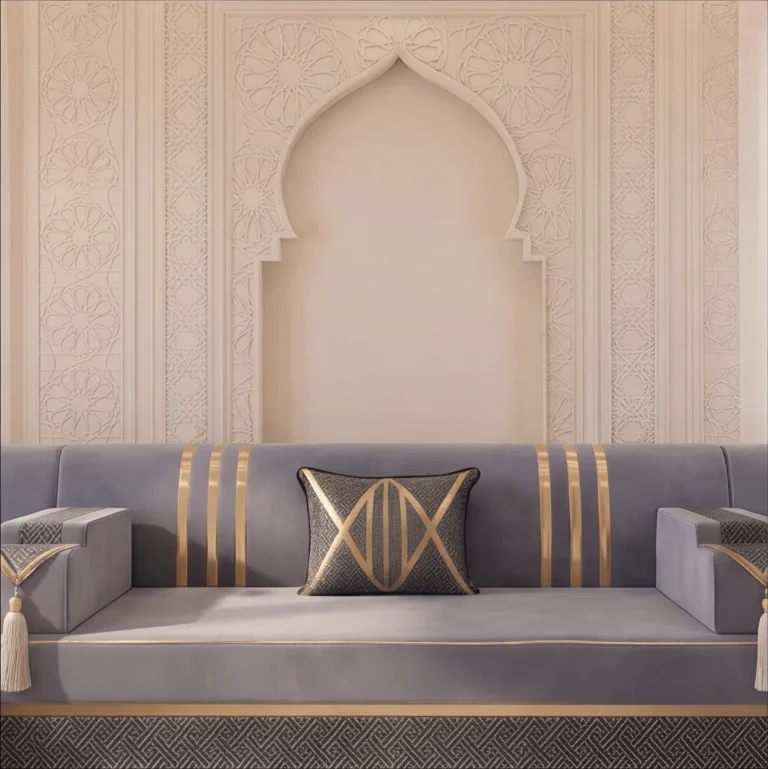 Centre section of a grey velvet majlis sofa set with gold stripes and one cushion below a tall carved arch niche
