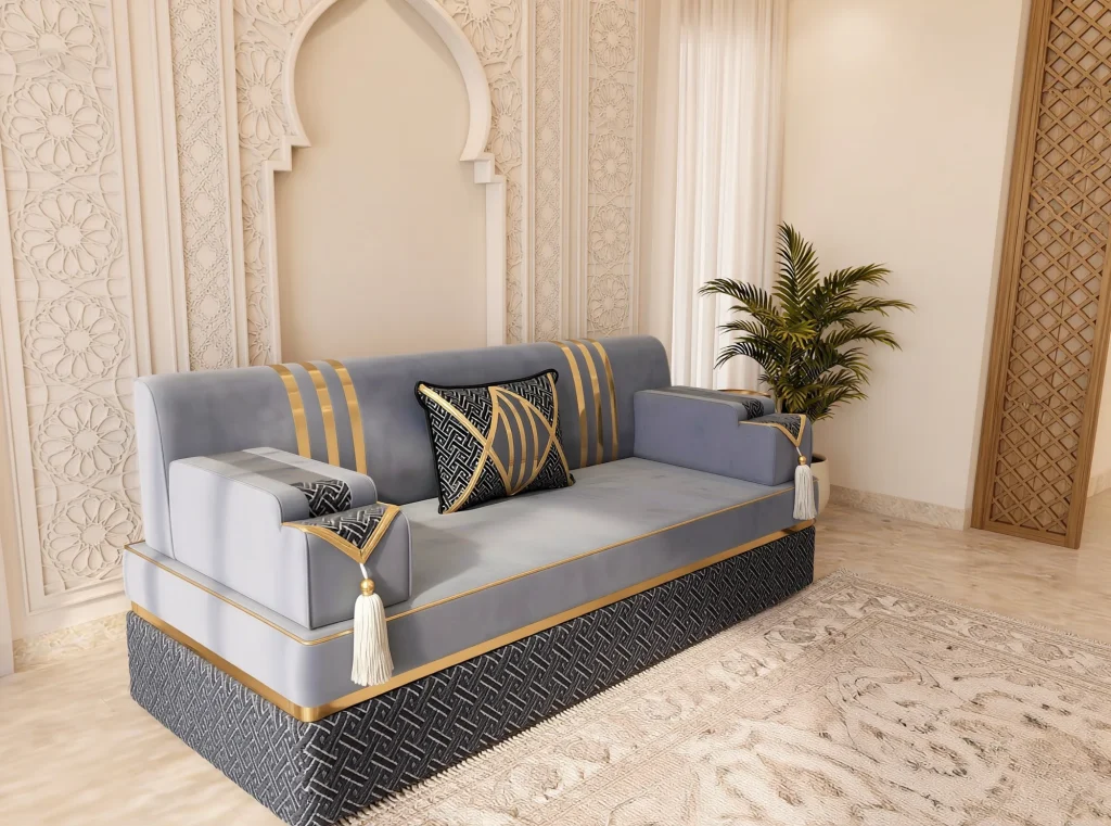High-angle view of a single grey velvet Arabic majlis seat with gold stripes and a black patterned base