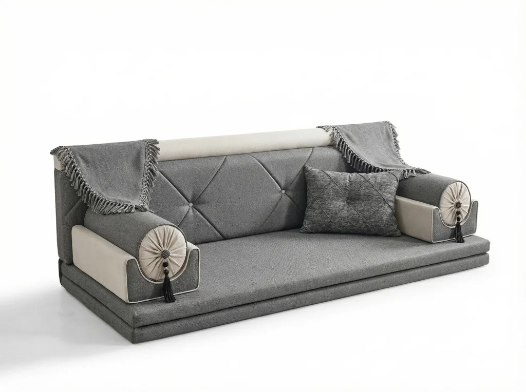 Low grey woven majlis seating piece with a diamond-tufted back, fringed throws and cream rosette bolsters